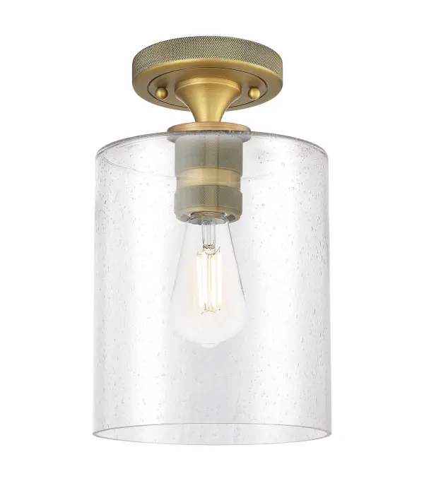 Details abound in the Crown Point Collection with an industrial take on modern sophistication. This stunning line of fixtures features cylindrical glass set in an updated restoration style frame with intricate knurling detail on the sockets, canopy, and finials.